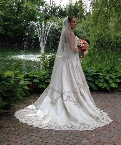 Wedding Dresses with Sheer Sleeve and Sequined Cuffs and Bow at the Waist and Embroidered Skirt and Belt and Embroidered Floral Patterns for an Elegant and Intricate LookAmalia Carrara 104 cp-11 Wedding Dresses with Sheer Sleeve and Sequined Cuffs and Bow at the Waist and Embroidered Skirt and Belt and Embroidered Floral Patterns for an Elegant and Intricate LookAmalia Carrara 104 cp-11