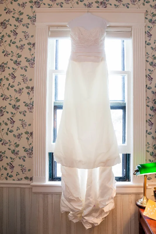 Wedding Dresses with Beaded Floral Wreath on the Bodice and High Low Hem and Belt for a Delicate and Dramatic LookAmy Kuschel Parfait Wedding Dresses with Beaded Floral Wreath on the Bodice and High Low Hem and Belt for a Delicate and Dramatic LookAmy Kuschel Parfait