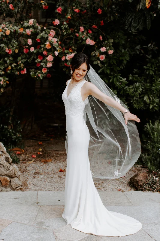 Wedding Dresses with Sequined Hearts and Ruffled Hem and Satin and Lace Combo and Bow at the Waist and Embroidered Floral Patterns for a Romantic and Feminine LookAmy Kuschel Vieve Wedding Dresses with Sequined Hearts and Ruffled Hem and Satin and Lace Combo and Bow at the Waist and Embroidered Floral Patterns for a Romantic and Feminine LookAmy Kuschel Vieve