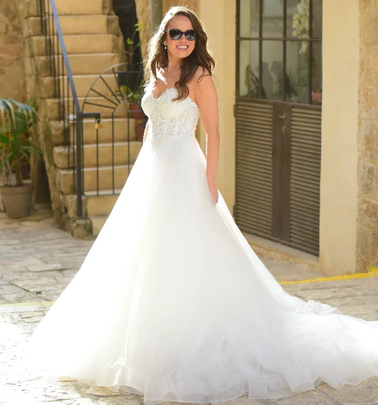 Wedding Dresses with Ruffled Sleeveless Top and Embroidered Skirt and Sequined Bodice for a Dramatic and Artistic LookAngel Rivera Crystal Wedding Dresses with Ruffled Sleeveless Top and Embroidered Skirt and Sequined Bodice for a Dramatic and Artistic LookAngel Rivera Crystal