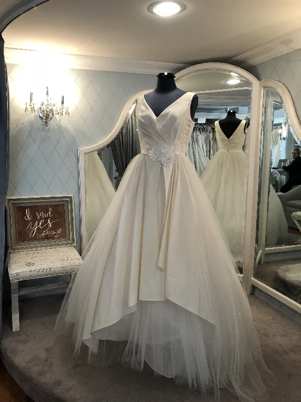 Wedding Dresses with Satin Trimmed Collar and Ruffled Hem and Bow at the Waist for a Classic and Girly LookAngel Sanchez 1508 Wedding Dresses with Satin Trimmed Collar and Ruffled Hem and Bow at the Waist for a Classic and Girly LookAngel Sanchez 1508