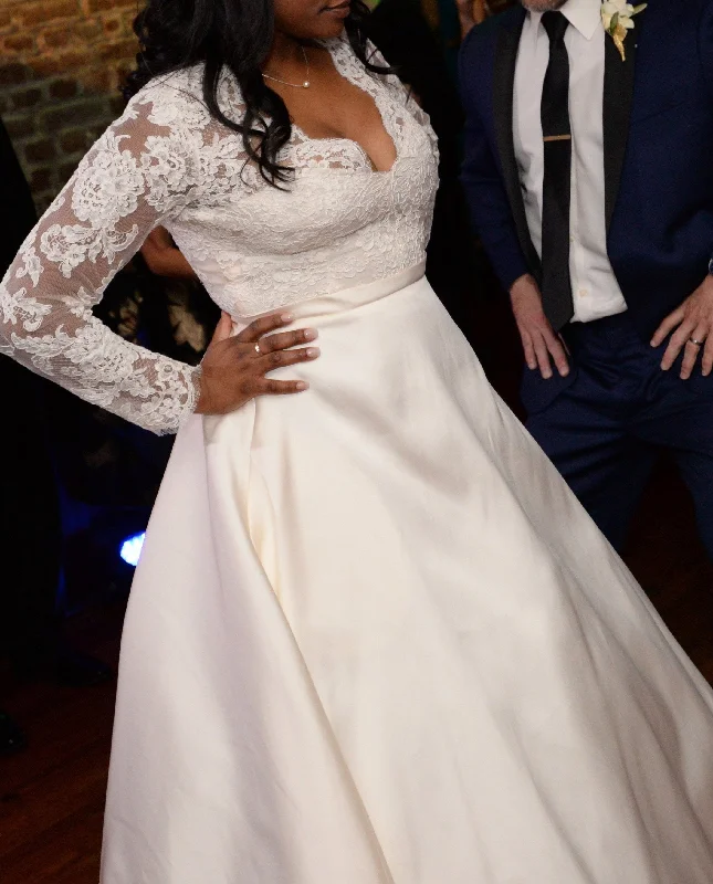 Wedding Dresses with Sheer Sleeve and Sequined Cuffs and Bow at the Waist and Embroidered Skirt and Belt and Embroidered Floral Patterns for an Elegant and Intricate LookAnne Barge Brooks Wedding Dresses with Sheer Sleeve and Sequined Cuffs and Bow at the Waist and Embroidered Skirt and Belt and Embroidered Floral Patterns for an Elegant and Intricate LookAnne Barge Brooks