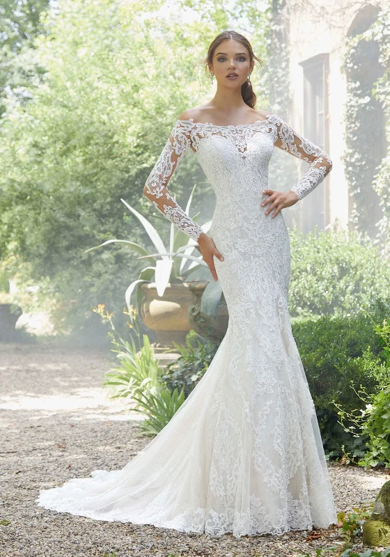 Wedding Dresses with Pleated Skirts and Lace Overlay and Bow at the Back for a Feminine and Timeless LookMorilee Priscilla - Size 18W Wedding Dresses with Pleated Skirts and Lace Overlay and Bow at the Back for a Feminine and Timeless LookMorilee Priscilla - Size 18W