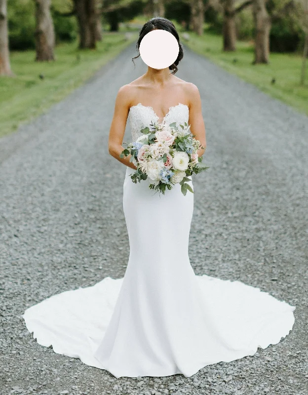 Wedding Dresses with Ruffled Hem and Bow at the Waist and Satin Ribbon and Embroidered Floral Patterns for a Sweet and Feminine LookEnzoani Marnie Wedding Dresses with Ruffled Hem and Bow at the Waist and Satin Ribbon and Embroidered Floral Patterns for a Sweet and Feminine LookEnzoani Marnie