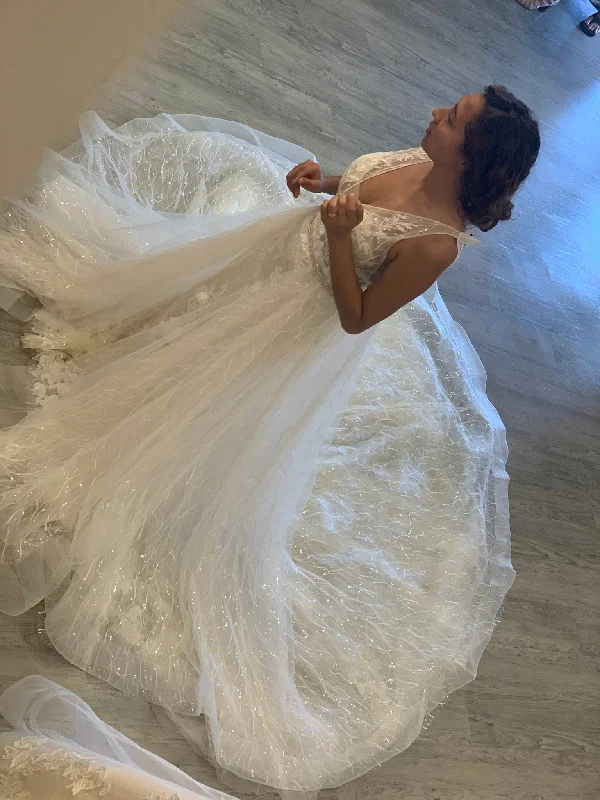 Wedding Dresses with Tulle Overlay and Beaded Bodice and High Low Hem and Embroidered Birds for a Dramatic and Graceful LookEnzoani Nurit Overskirt Wedding Dresses with Tulle Overlay and Beaded Bodice and High Low Hem and Embroidered Birds for a Dramatic and Graceful LookEnzoani Nurit Overskirt