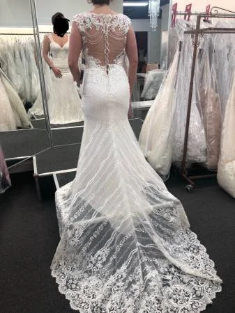 Wedding Dresses with Satin and Lace Trimmed Neckline and Ruffled Sleeves and Embroidered Skirt and Bow at the Back and Belt for a Sophisticated and Girly LookMon Cheri Eden Wedding Dresses with Satin and Lace Trimmed Neckline and Ruffled Sleeves and Embroidered Skirt and Bow at the Back and Belt for a Sophisticated and Girly LookMon Cheri Eden