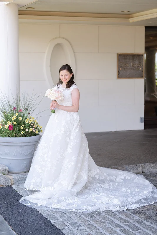 Wedding Dresses with Pleated Skirts and Lace Overlay and Bow at the Back for a Feminine and Timeless LookMonique Lhuillier Easton Wedding Dresses with Pleated Skirts and Lace Overlay and Bow at the Back for a Feminine and Timeless LookMonique Lhuillier Easton