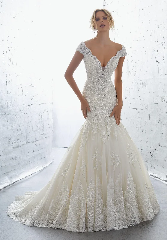 Wedding Dresses with Sheer Sleeve and Sequined Cuffs and Bow at the Waist and Embroidered Skirt and Belt for an Elegant and Intricate LookMori Lee Karisma Wedding Dresses with Sheer Sleeve and Sequined Cuffs and Bow at the Waist and Embroidered Skirt and Belt for an Elegant and Intricate LookMori Lee Karisma