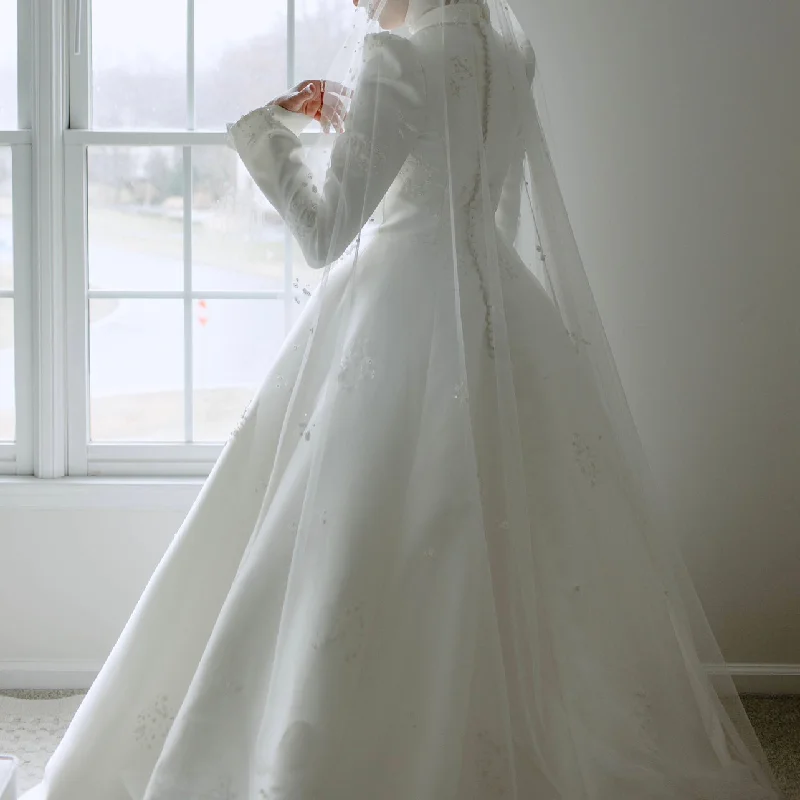 Wedding Dresses with Satin Trimmed Collar and Bow Back and Embroidered Skirt and Sequined Bodice and Belt for a Classic and Glamorous LookOther Regal High Neck Long Sleeved A-Line Wedding Dresses with Satin Trimmed Collar and Bow Back and Embroidered Skirt and Sequined Bodice and Belt for a Classic and Glamorous LookOther Regal High Neck Long Sleeved A-Line