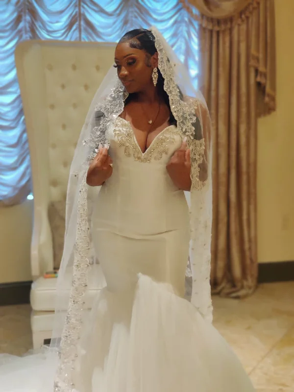 Wedding Dresses with Ruffled Hem and Bow at the Waist and Satin Ribbon and Embroidered Floral Patterns for a Sweet and Feminine LookOther Soleil Wedding Dresses with Ruffled Hem and Bow at the Waist and Satin Ribbon and Embroidered Floral Patterns for a Sweet and Feminine LookOther Soleil