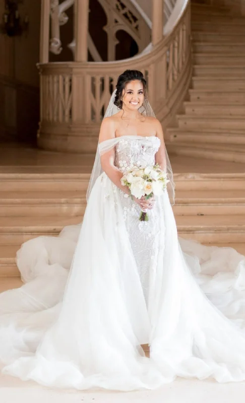 Wedding Dresses with Beaded Floral Wreath on the Bodice and Tulle Skirt and High Neck for a Delicate and Festive LookPallas Couture Lille & Overskirt Wedding Dresses with Beaded Floral Wreath on the Bodice and Tulle Skirt and High Neck for a Delicate and Festive LookPallas Couture Lille & Overskirt