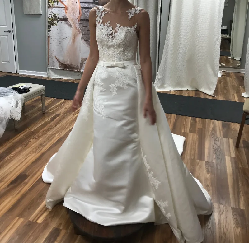 Wedding Dresses with Satin Trimmed Collar and Ruffled Hem and Bow at the Waist for a Classic and Girly LookPronovias Dranoe