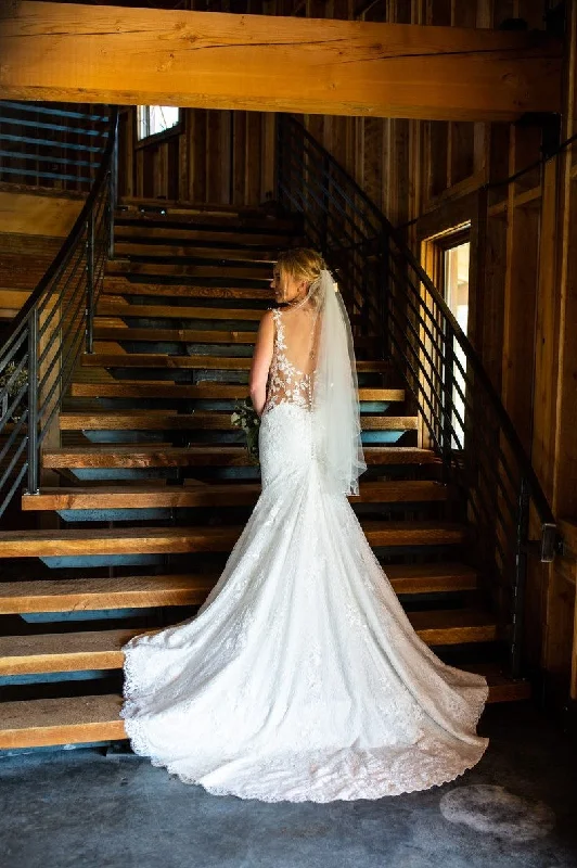 Wedding Dresses with Lace Insertions on the Skirt and Beaded Waistband and Ruffled Hem and Bow at the Waist and Embroidered Floral Patterns for a Feminine and Flirty LookPronovias Morocco Wedding Dresses with Lace Insertions on the Skirt and Beaded Waistband and Ruffled Hem and Bow at the Waist and Embroidered Floral Patterns for a Feminine and Flirty LookPronovias Morocco