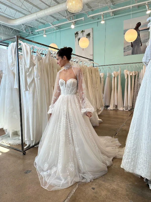 Wedding Dresses with Lace Insertions on the Skirt and Beaded Waistband and Ruffled Hem and Bow at the Waist for a Feminine and Flirty LookRish Bridal Aspen Wedding Dresses with Lace Insertions on the Skirt and Beaded Waistband and Ruffled Hem and Bow at the Waist for a Feminine and Flirty LookRish Bridal Aspen